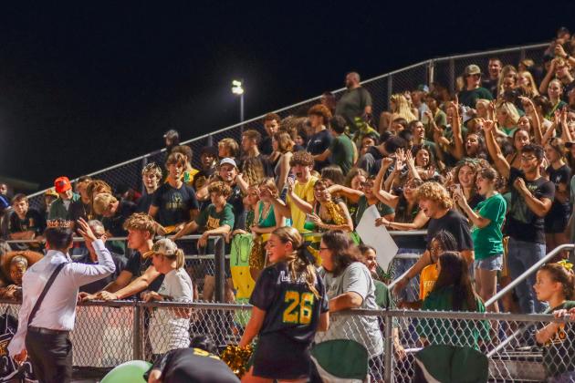 Yulee High School students and fans applaud the newly crowned homecoming king and queen. Photo by Ashley Chandler/News-Leader