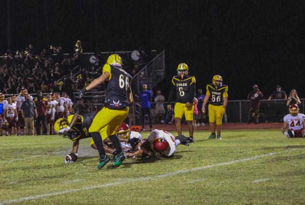 The Hornets defense tackles a Warrior. Photo by Marisa DeMar/News-Leader