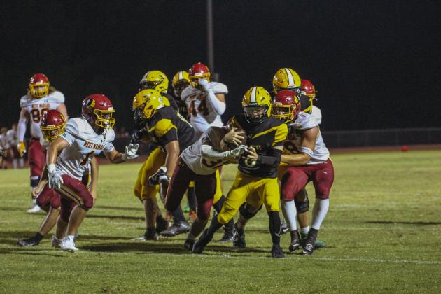 Quarterback Tre Vazquez carries the ball for Yulee in the Hornets’ win over the Warriors.
