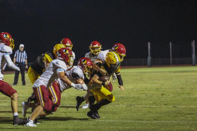 Quarterback Tre Vazquez carries the ball for Yulee in the Hornets’ win over the Warriors.