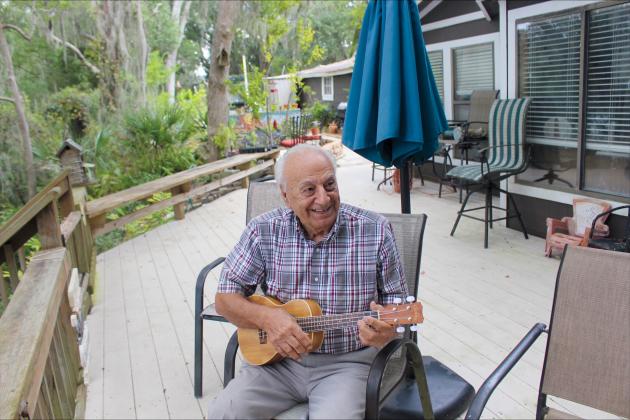 George Crady, 94, plays his ukulele and sings at his home on Crady Lake on Oct. 1.  Marisa DeMar/News-Leader 