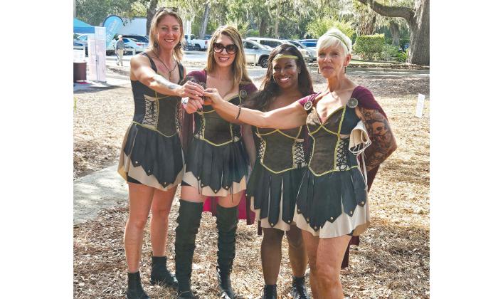 Amazonian Anvils team members Joanna Yates, Kariana Haynes, Tiffany Messer and Gina Maloney during the First Coast Habitat fundraiser She Nailed It! on Sunday at Racquet Park in Fernandina Beach. Photo by Jim Luksic/News-Leader