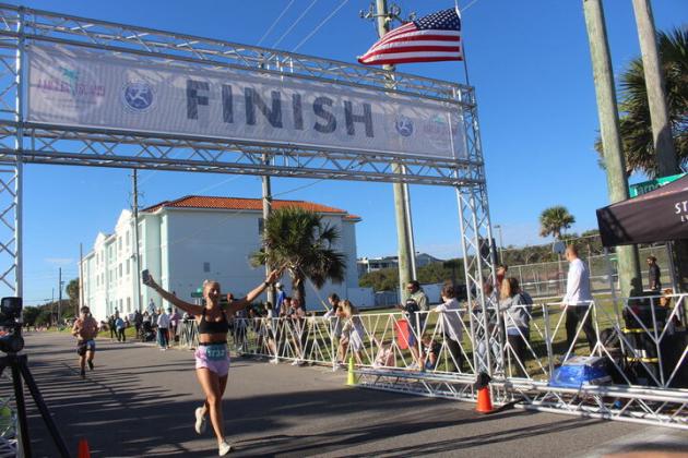 Runner crosses the finish line at the Amelia Island Half Marathon on Sunday By Marisa DeMar/News-Leader 