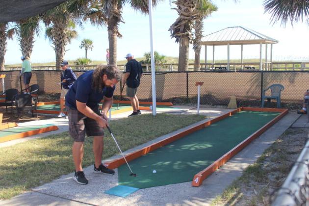 Miniature golfers in action during the Putt-Putt championship on Thursday.  By Marisa DeMar  News-Leader