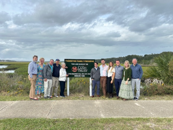 The Thornton Family poses for a photo in front of a sign by the North Florida Landtrust’s conservation land, more than 350 acres donated to NFLT by the family.
