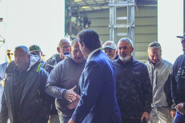 Gov. DeSantis shakes hands with fisherman following his news conference in Fernandina Beach on Monday.