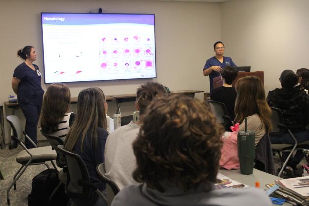 Photo by Pam Bushnell / Jamie Dill and David Huynh of Baptist Medical Center Nassau laboratory department give students a look at the facets of their work.