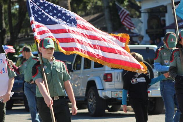 Local boy scouts walk in the in the Fernandina Beach Veterans Day Parade on Tuesday. By Marisa DeMar/News-Leader