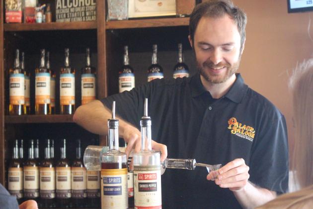 Walker Lee serves customers a taste of their house-made liquors at Marlin &amp; Barrel tasting room on Oct. 30.
