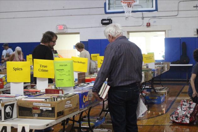 Readers browse the book sale hosted by the Friends of the Fernandina Beach Library in the Peck Center Gymnasium on Nov. 6. By Marisa DeMar/News-Leader