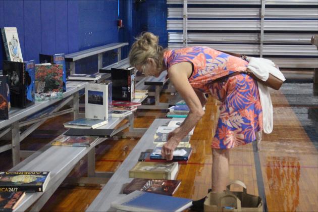 Readers browse the book sale hosted by the Friends of the Fernandina Beach Library in the Peck Center Gymnasium on Nov. 6. By Marisa DeMar/News-Leader