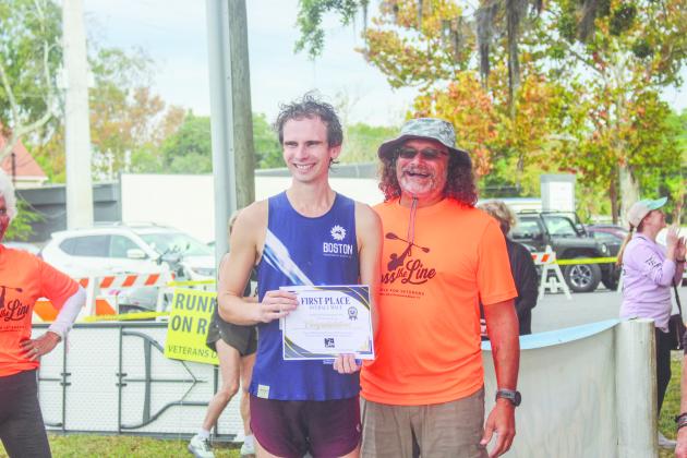 The winner of the 5K, Bryan Robison poses with Cross the Line co-founder Paul Lore after the race on Saturday.