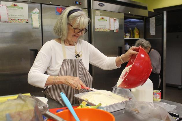 Photos by Marisa DeMar/News-Leader  Volunteers at Gracie’s Kitchen prepare a meal for their drive-up meal service on Thursday, Nov. 13. 
