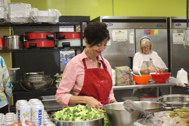 Volunteers at Gracie’s Kitchen prepare a meal for their drive-up meal service on Thursday, Nov. 13. 