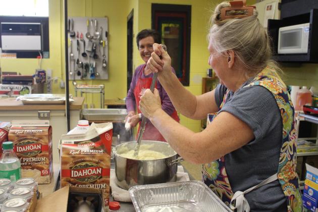 Volunteers at Gracie’s Kitchen prepare a meal for their drive-up meal service on Thursday, Nov. 13. 