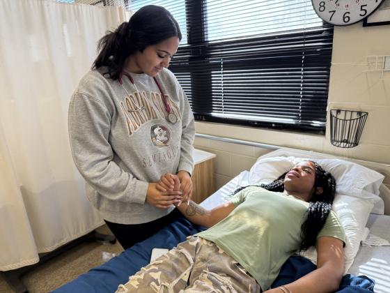 Eriyhanna Hamm assists Savion Roberts during class at Fernandina Beach’s nursing program. Photo by Nick Blank/News-Leader