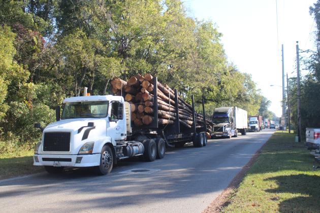 A line of trucks form outside the RYAM factory in Fernandina Beach after being halted by security. Photo By Marisa DeMar/News-Leader