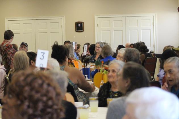 The smiling crowd enjoys their Thanksgiving lunch. By Marisa DeMar/News-Leader