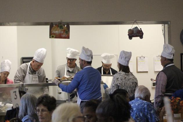 The "celebrity chefs" gear up to serve thanksgiving meals at the luncheon. By Marisa DeMar/News-Leader