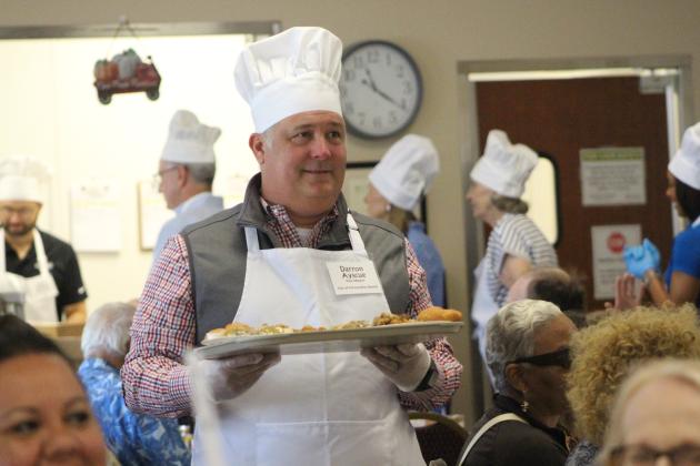 Vice Mayor Darron Ayscue serves plates of food at the NCCOA Thanksgiving Luncheon. By Marisa DeMar/News-Leader