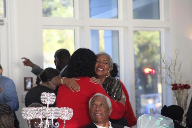 Friends share an embrace after entering the American Beach Gala. Photos by Marisa DeMar