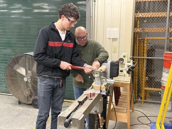 Nick Blank/News-Leader  Luke Gray uses a lathe as Yulee High School instructor Ray Hart watches.