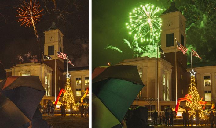 Attendees of the Nassau County tree lighting event Friday watch the fireworks that followed the lighting from under umbrellas at the Robert M. Foster Justice Center in Yulee. Photo by Ashley Chandler/News-Leader