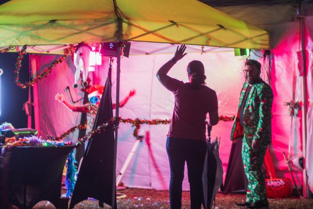 Attendees of the Nassau County tree lighting event Friday watch the fireworks that followed the lighting from under umbrellas at the Robert M. Foster Justice Center in Yulee. Photo by Ashley Chandler/News-Leader