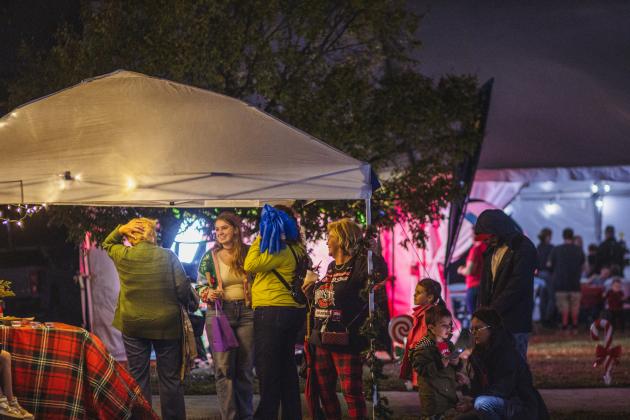 Attendees of the Nassau County tree lighting event Friday watch the fireworks that followed the lighting from under umbrellas at the Robert M. Foster Justice Center in Yulee. Photo by Ashley Chandler/News-Leader