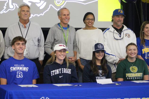 Cook, Foxwell-Jones, Scuderi, and Murallo pose with their high school coaches at FBHS during National Signing Day.  By Marisa DeMar/News-Leader