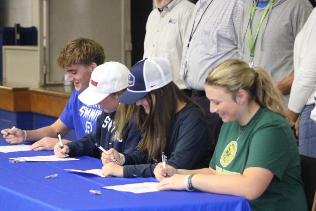 Group shot of all four FBHS athletes signing their letters of commitment on National Signing Day, Wednesday. By Marisa DeMar/News-Leader 