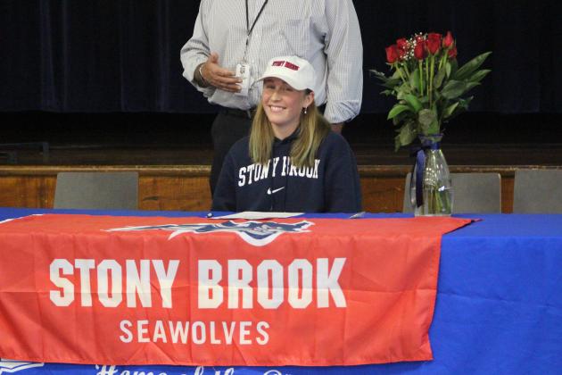 Cora Foxwell-Jones signs her commitment letter to persue swimming at Stony Brook University in New York.  By Marisa DeMar/News-Leader