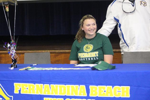 Rylee Murallo smiles as she signs her commitment letter to play softball at Piedmont University in Georgia. By Marisa DeMar/News-Leader