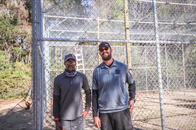 Tony Clardy and Jake Stephenson pose in front of the unfinished monkey enclosure on Jan 1. By Marisa DeMar/News-Leader 