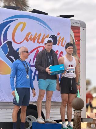 The male winners Charlie Stewart, Henry Stewart and Gavin Furlong accept their prizes on the podium after the race. Submitted photo