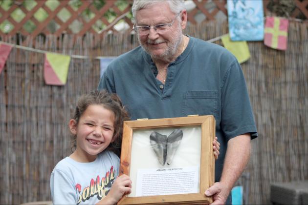 Remy Hayes and Herb Ferguson pose with the shark tooth match that sparked the idea for the speed dating event. By Marisa DeMar/News-Leader