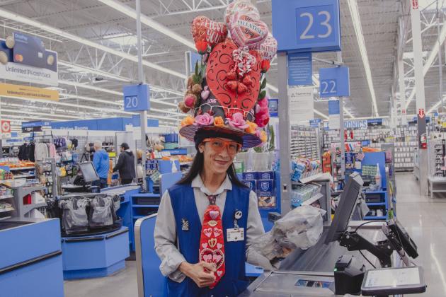 Marlon (Maui) Capule wears a homemade Valentine’s Day themed hat while working as a cashier at Walmart in Yulee on Wednesday. 