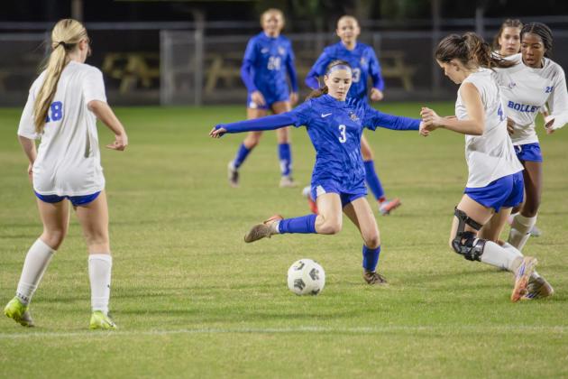 Evie Oliver looks for a teammate through two Bolles players during Wednesday’s District Championship. Nick Blank/News-Leader