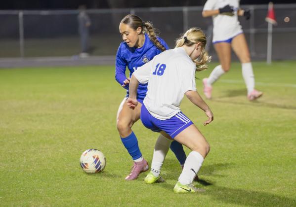 Freshman Kadence Gallup pushes the ball past a defending player in Wednesday’s District Championship against Bolles.