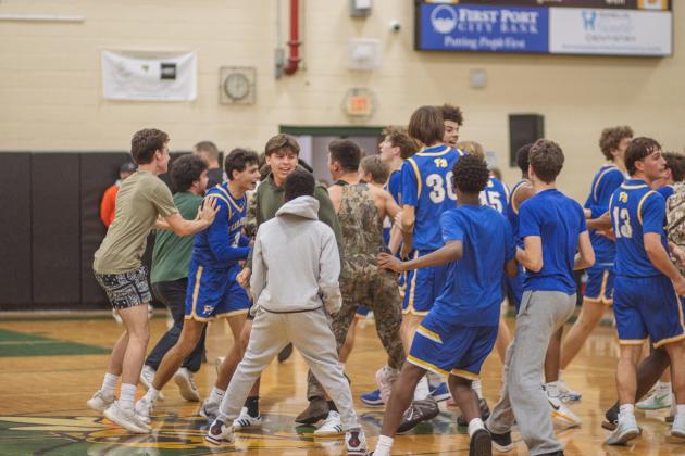 Fernandina Beach High School students and varsity basketball players celebrate in the Yulee High School gymnasium after the Pirates beat the Hornets by two points on Friday. Photo by Ashley Chandler/News-Leader