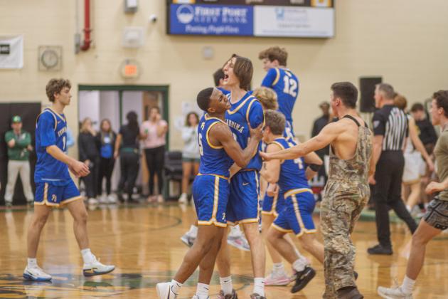 Fernandina Beach High School students and varsity basketball players celebrate in the Yulee High School gymnasium after the Pirates beat the Hornets by two points on Friday. Photo by Ashley Chandler/News-Leader