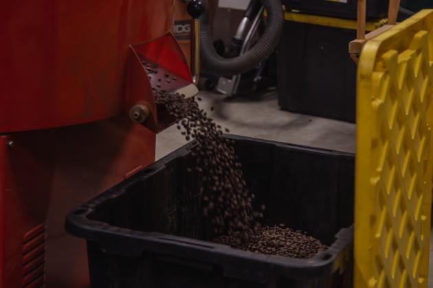 The coffee roaster dispenses roasted beans at Nuanz Coffee Roasters in Yulee.