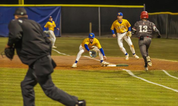 Grady Stevens catches the ball at first for an out against Baldwin on Feb. 13. Photo by Ashley Chandler/News-Leader