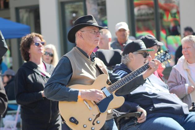 Musician serenades the crowd of the ChilI Cook-Off. By Marisa DeMar