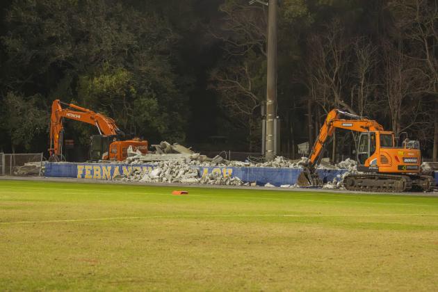 Excavators began tearing down the 40-year-old home bleachers at Fernandina Beach High School on Wednesday, part of a $2.4 million demolition and replacement. Photo by Ashley Chandler/News-Leader