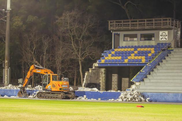 Excavators began tearing down the 40-year-old home bleachers at Fernandina Beach High School on Wednesday, part of a $2.4 million demolition and replacement. Photo by Ashley Chandler/News-Leader 