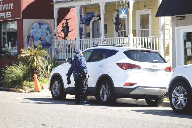 One Parking employee checks cars in the premium parking zone on Feb. 23. By Marisa DeMar/News-Leader