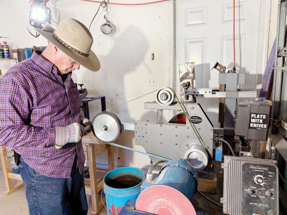 Knifemaker John Thompson grinds a knife in his workshop. Nick Blank/News-Leader