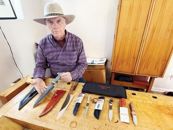 John Thompson shows a Damascus knife and other knives he’s crafted. Nick Blank/News-Leader