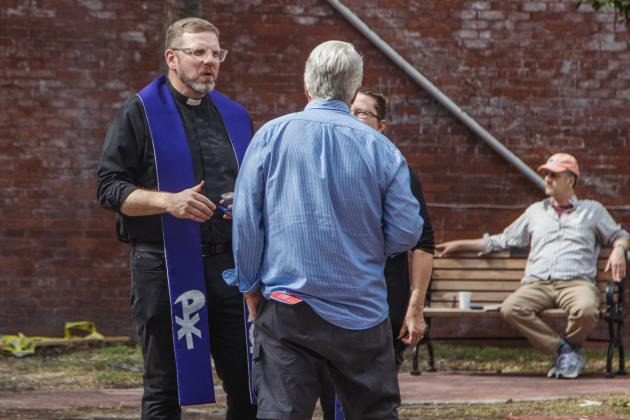 the Rev. Dr. Mark Charles, senior pastor at Memorial United Methodist Church, applies the imposition of ashes at Pocket Park in downtown Fernandina Beach. Photo by Ashley Chandler/News-Leader